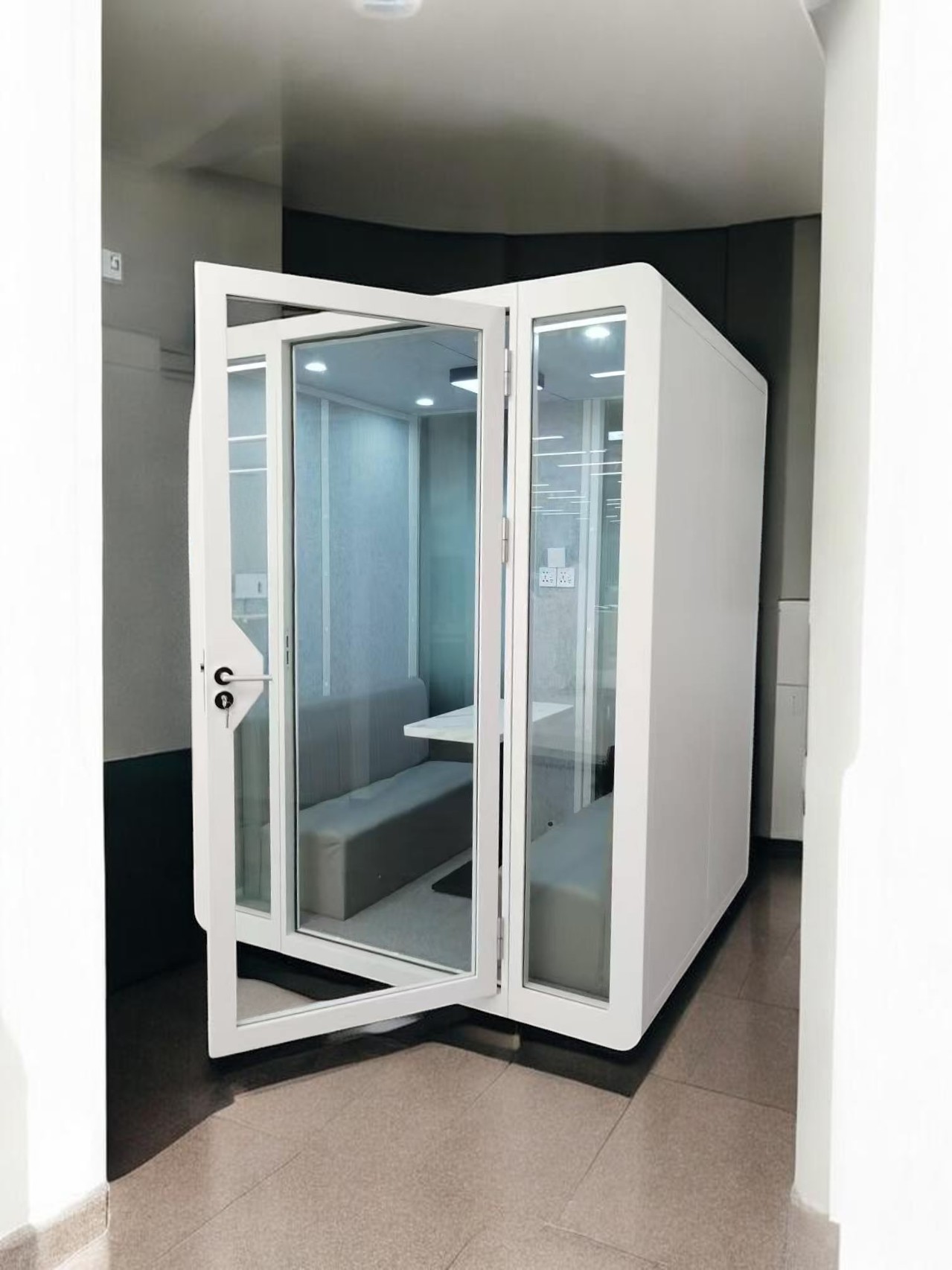 Ouvertu Meeting Pod with open glass door, seating for four inside